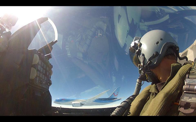 Illustration for article titled Extremely rare photo of two armed F-16s escorting a Boeing Dreamliner